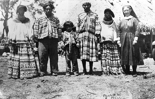 Deaconess Bedell posing with Miccosukee Indians at their camp